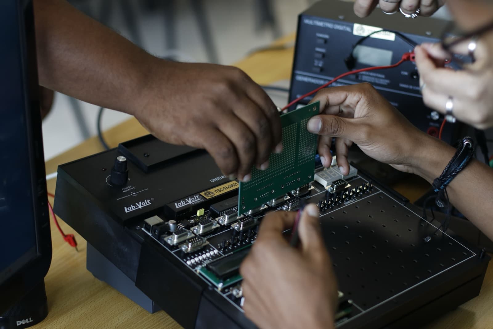 Hands assembling an electronic circuit board