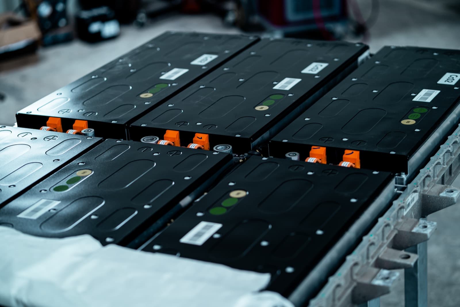 High-voltage battery modules staged on a rack during pack assembly