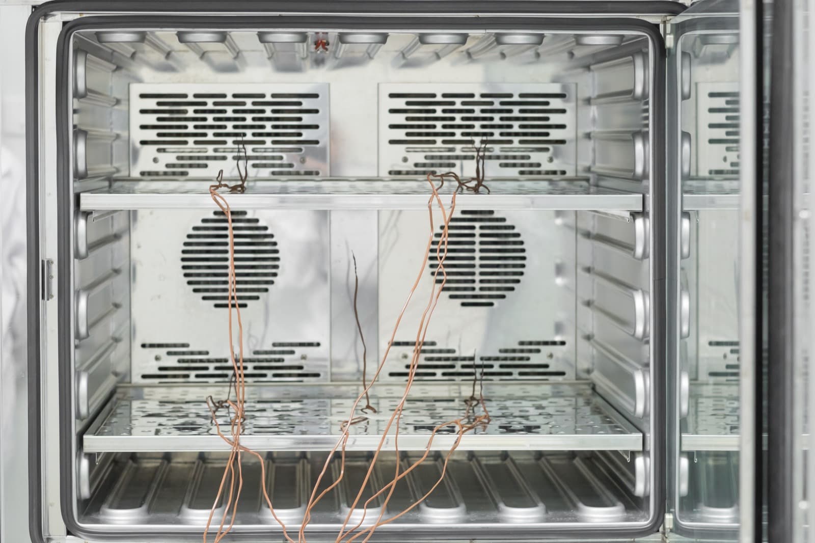 Stainless test chamber with thermocouple leads run across its shelves