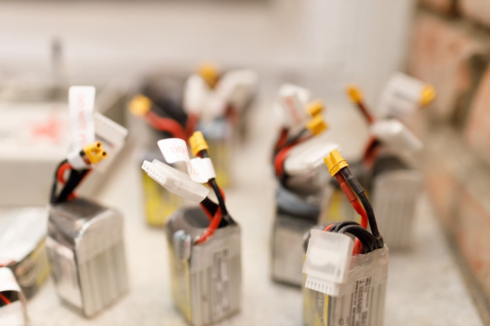 Drone lithium battery packs lined up on a bench